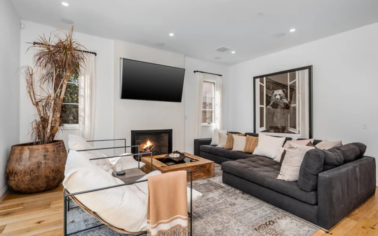 Living room with a flat screen TV mounted above a fireplace